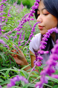 Beautiful asian woman smelling purple lavender flowers in the park outdoor