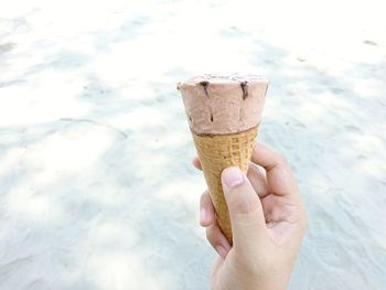 Close-up of hand holding ice cream cone