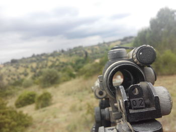 Close-up of coin-operated binoculars against sky