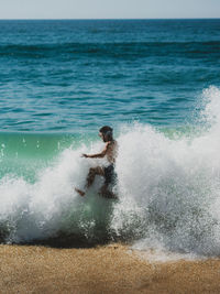 Man splashing water in sea