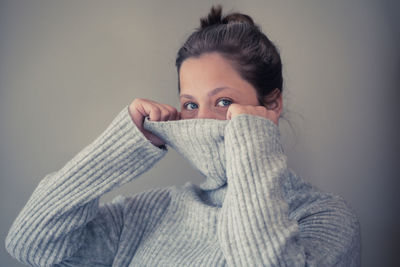 Portrait of woman covering face