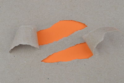 High angle view of orange paper on sand