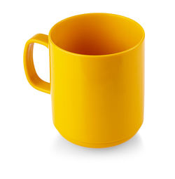 Close-up of orange cup against white background