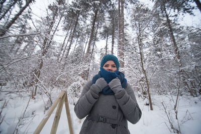 Portrait of man standing in snow