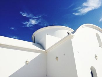 Low angle view of white building against blue sky