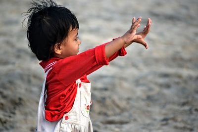 Side view of girl enjoying at beach