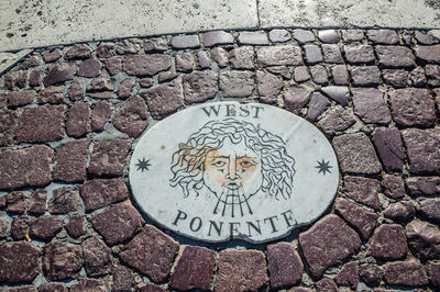 High angle view of text on footpath
