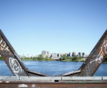 Bridge over river against clear blue sky