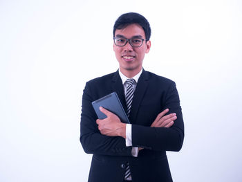 Portrait of young man against white background