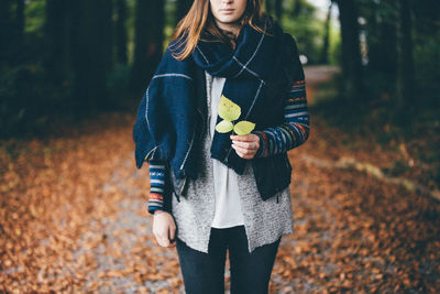 Young woman holding hands in forest