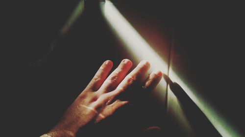 Close-up of human hand in darkroom