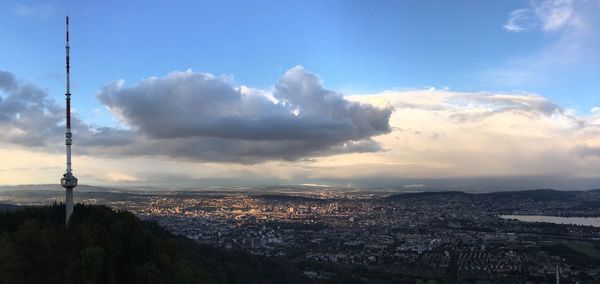 Aerial view of cityscape against cloudy sky