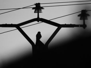 Low angle view of silhouette man against clear sky