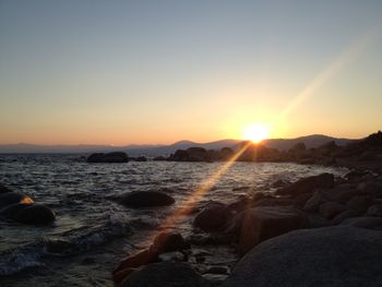 Scenic view of sea against clear sky during sunset