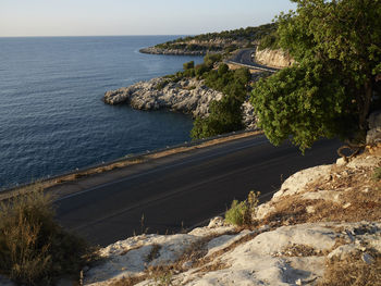 High angle view of street by sea against sky