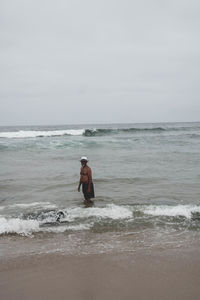 Man on beach against sky