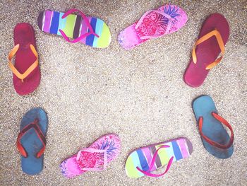 High angle view of multi colored shoes on sand