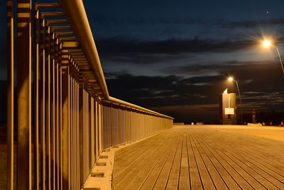 Illuminated bridge against sky at night