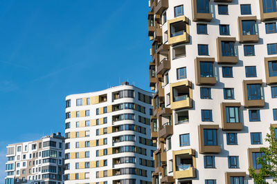 Low angle view of buildings against clear blue sky