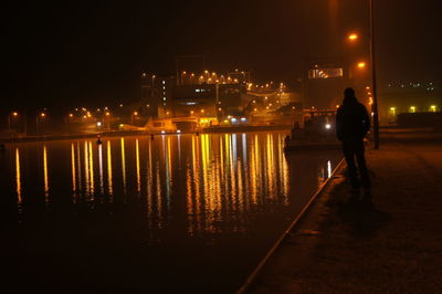 Full length of man in illuminated city at night