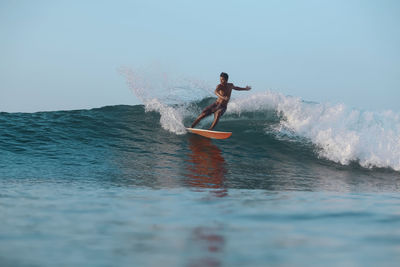 Surfer on a wave, lombok, indonesia