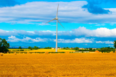 Rural landscape against cloudy sky