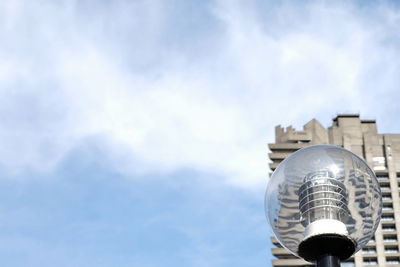 Low angle view of building against cloudy sky