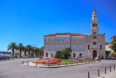 Church in town against clear blue sky