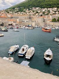 Boats moored at harbor