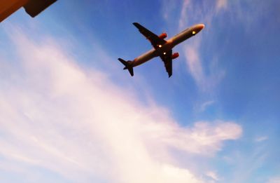 Low angle view of airplane flying in sky