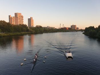 Scenic view of river by buildings against clear sky