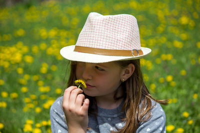 Portrait of girl wearing hat against plants