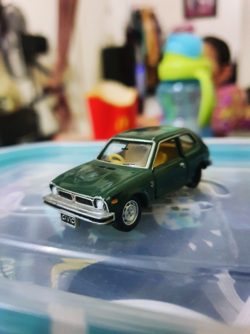 CLOSE-UP OF TOY CAR ON TABLE AT HOME