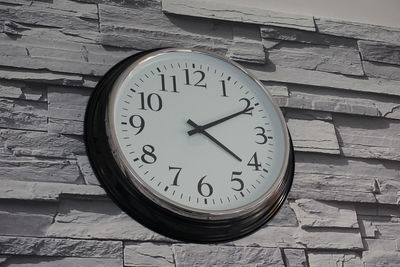 Low angle view of clock on wall