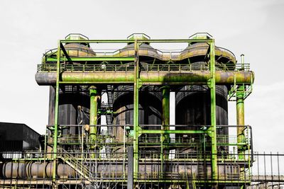 Low angle view of industry against clear sky