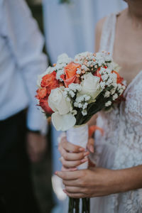 Close-up of hand holding flower bouquet