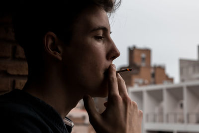 Close-up of young man smoking cigarette