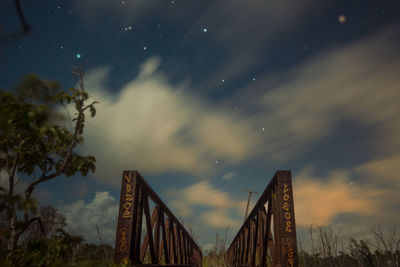 Low angle view of bridge against sky at night