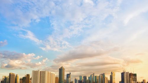 Panoramic view of modern buildings in city against sky