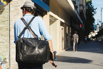 Rear view of man walking on street