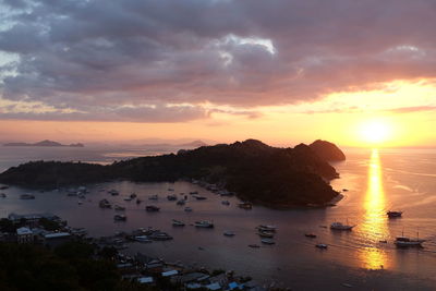 Sunset at labuanbajo indonesia with a view of boats for diving trips to komodo island.