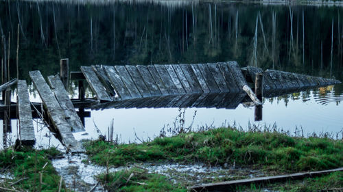 Wooden posts in lake