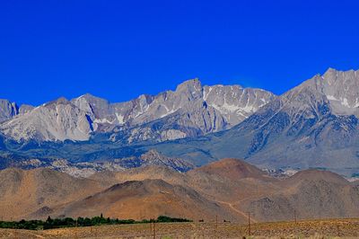 Scenic view of mountains against clear blue sky