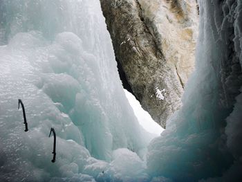 Low angle view of axes on ice formation