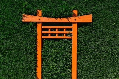 High angle view of empty benches on grassy field