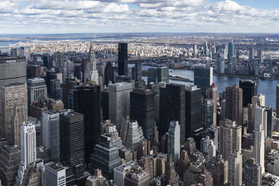 Aerial view of modern buildings in city against sky