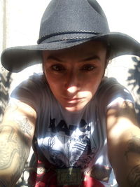 Portrait of young woman holding hat