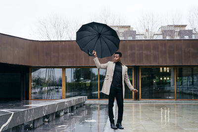 Full length of man standing on wet rainy day