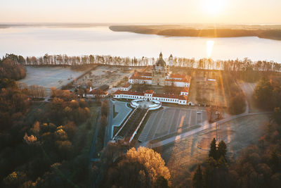 Aerial view of cathedral against sea during sunset