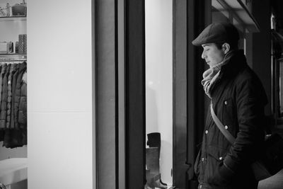 Midsection of man standing in corridor